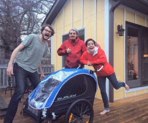 Runners Evan Flom, Alex Butter and Allissa Stutte gather around their new baby stroller.
